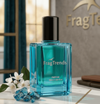Fragrance bottle labeled 'FragTrends Coastal Azure' on a marble surface with decorative elements.